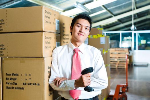 Young Man in a warehouse with Scanner