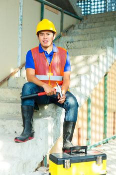 Asian Indonesian construction worker on building site