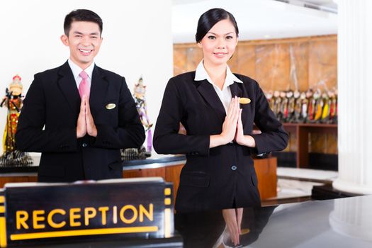 Chinese Asian reception team at hotel front desk
