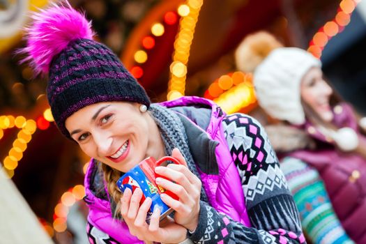 Woman drinking eggnog on German Christmas Market