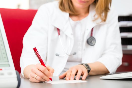 Doctor writing medical certificate in practice
