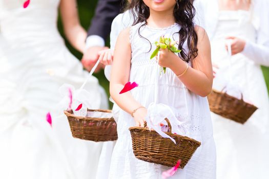 Wedding bridesmaids with flower petal basket