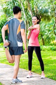 Asian couple having outdoor fitness sport training