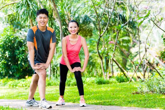 Asian couple having outdoor fitness sport training