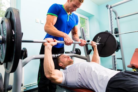 Men in sport gym training with barbell for fitness