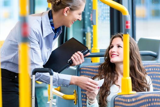 Woman in bus having no valid ticket at inspection
