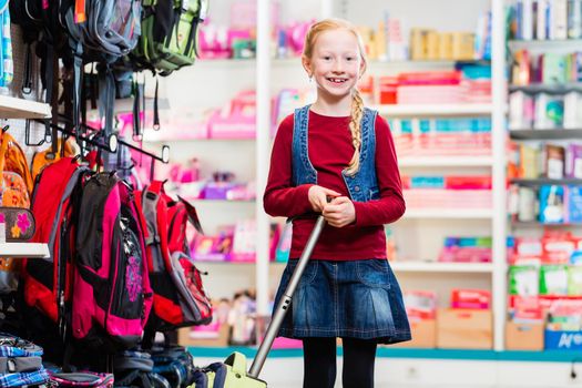 Pupil buying supplies for first day in school