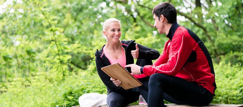 Woman with personal trainer at running evaluation