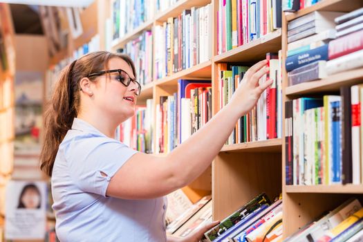 Woman in bookstore looking for book