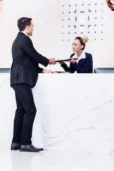 Applicant giving his documents to receptionist