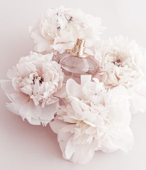 Fragrance bottle as luxury perfume product on background of peony flowers, parfum ad and beauty branding
