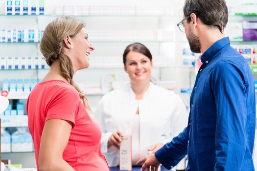 Woman and man buying drugs in pharmacy