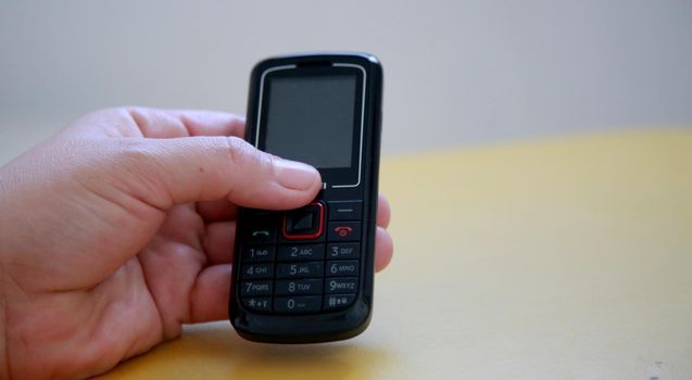hand holding analog cellphone