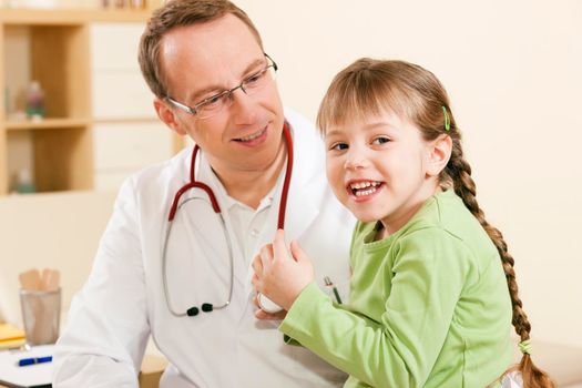 Pediatrician doctor with child patient 