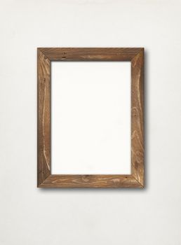 Old rustic wooden picture frame hanging on a white wall