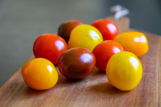 Cocktail tomatoes on a cutting board