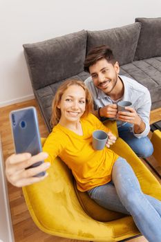couple drinking coffee and taking selfie