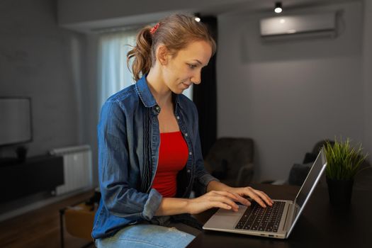 Girl working on a laptop at home