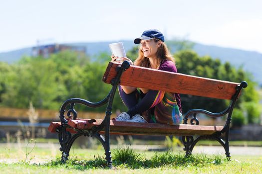 girl on a bench reading a book