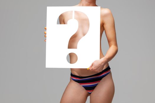 nude girl holding stencil question mark character