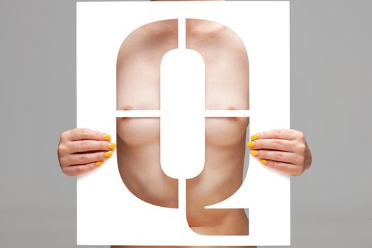 nude girl holding stencil letter q