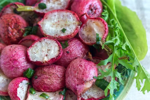 Baked radish with green onions on a plate
