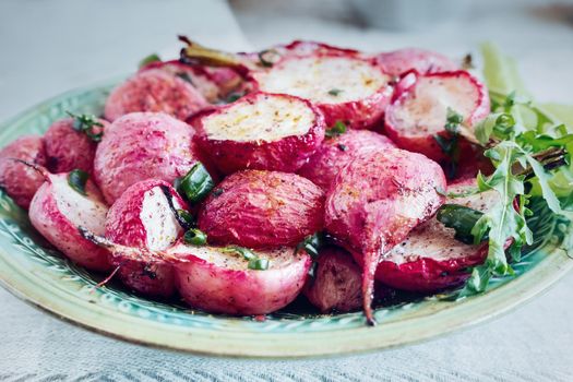 Baked radish with green onions on a plate
