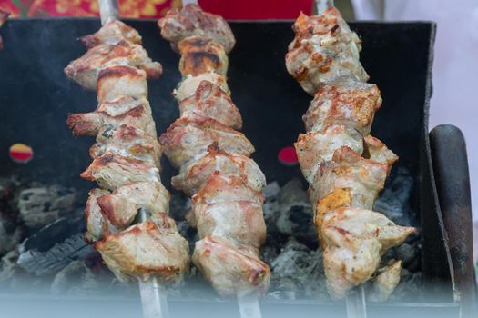 Shish kebab on skewers roasting on the grill