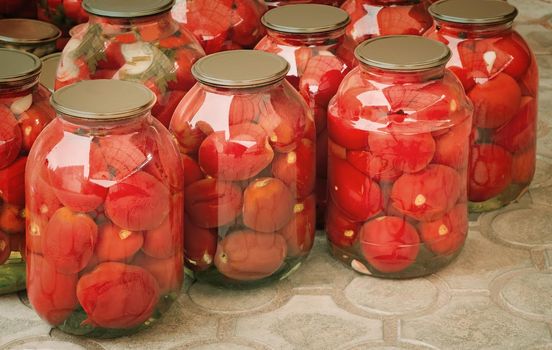  Tinned tomatoes in big glass jars.