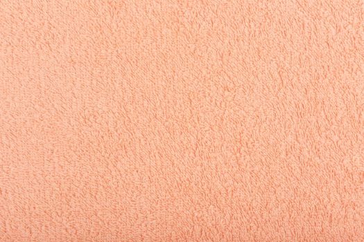 Orange fuzzy towel background. Fleecy fabric close up with space for text