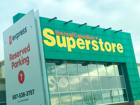 Calgary Alberta, Canada. Oct 17, 2020. The real canadian superstore building with the PC express reserved Parking for picking up groceries.