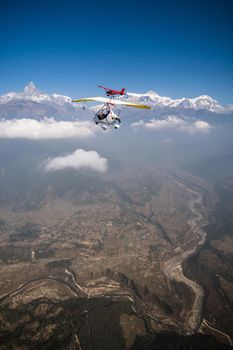 Ultralight trike and plane fly over Pokhara and Annapurna region