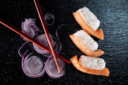 Sushi with red onion garnish