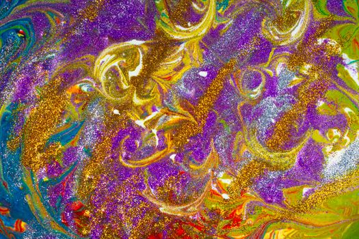 Multicolored acrylic background with curls sprinkled with purple and gold sparkles. Contemporary creativity. A colorful avant-garde painting with rich texture. A background made up of many shapes and materials.