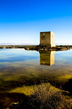 Beautiful Tamarit tower surrounded by salt lagoons in Santa Pola, Alicante, Spain