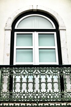 Typical vintage portuguese facade with forged metal balcony