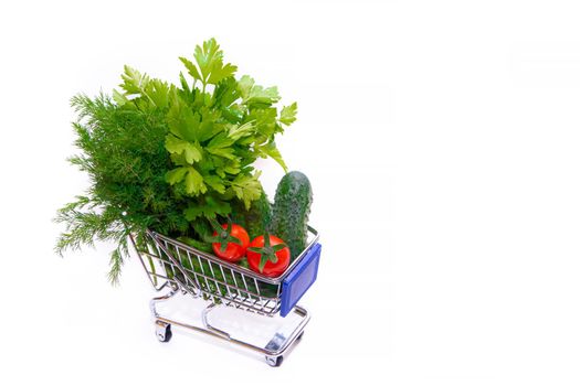 Cart with vegetables and herbs . Buying vegetables. Vegetarianism. Online purchases. Order products online. Coronavirus. Article about the benefits and harm of vegetables. Products for vegetable salad in the cart. copy space