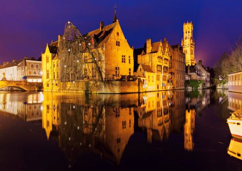 Belfry of Bruges reflected in the canal