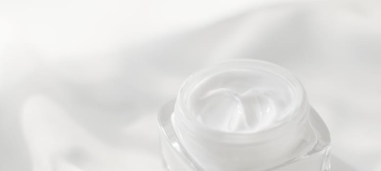 Face cream moisturizer jar on silk background, moisturizing skin care lotion and lifting emulsion, anti-age cosmetics for luxury beauty skincare brand