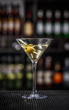Martini cocktail with green olives