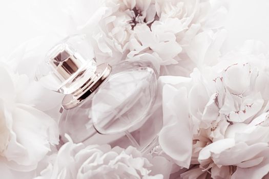 Chic fragrance bottle as luxe perfume product on background of peony flowers, parfum ad and beauty branding
