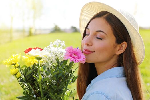 Brazilian pretty beautiful girl smells flowers outdoor
