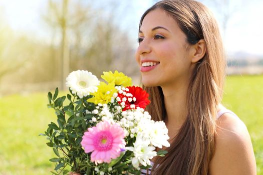 Happy beautiful girl receives a bouquet of flowers on International Women's Day
