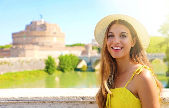 Smiling beautiful tourist girl in Rome, Italy. Attractive fashion young woman with Castel Sant Angelo castle on the background.
