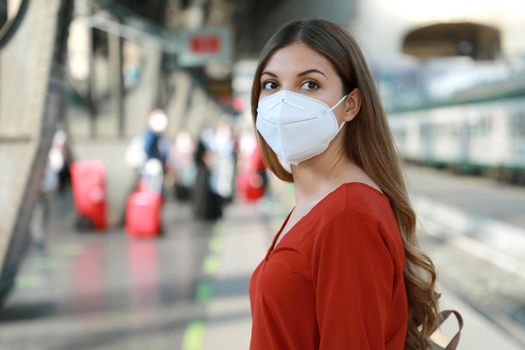 Portrait of casual woman waiting train with KN95 FFP2 protective mask at train station