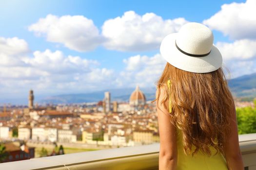 Tourism in Italy. Back view of young woman enjoying panoramic view of Florence city, Tuscany, Italy.