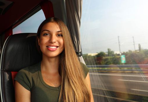 Young beautiful woman in bus smile at camera