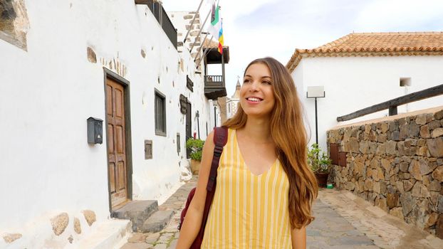 Young traveler girl visits small colonial village of Betancuria, Canary Islands, Spain