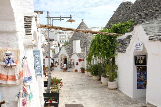 ALBEROBELLO, ITALY - JULY 17, 2020: the village of Alberobello with souvenir shops in Trulli houses, Puglia, Italy