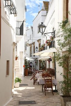 Glimpse of an Italian town with restaurants outside in Apulia region, southern Europe